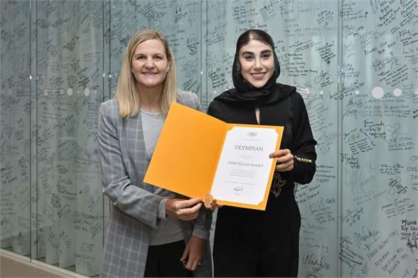 Iranian Olympic Silver Medalist Nahid Kiani Signs the Olympic Wall